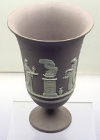 Auktion 373<br>neoklassizistische Wedgwood Jasperware Vase &bdquo;Arcadian&ldquo;-auf Fu&szlig;, Fliederfarben Reliefs mit klassischen weissen Opferszenen, H-19,5 cm