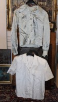 Auktion 376 / Los 13009 <br>zwei silber- bzw. cremefarbene Satin- oder Seidenblusen mit spitzem Hemdkragen und durchgehender Knopfleiste