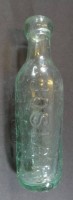 Auktion 332 / Los 10049 <br>Sattelflasche "Josiah H. Russel" hellgrün, um 1900, L-18 cm, ca. 0,25 L