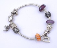 Auktion 333 / Los 1026 <br>Pandora Armband mit 11 Charms, Sterling Silber 0.925 ALE, 52,5g.