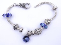 Auktion 333 / Los 1029 <br>LAA Armband mit Charms, Sterling Silber 0.925 L. 20cm, Schliesst nicht, da Öse zu klein,31g.