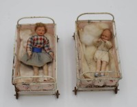 Auktion 334 / Los 12033 <br>2x Puppen-Bettchen anbei 2 Biege-Püppchen, wohl 20/30er Jahre, Bett ca. 7,5cm B-9,8cm.