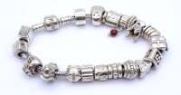 Auktion 338 / Los 1073 <br>Pandora Armband mit 19 Charms, Silber 925, L. 19cm, 64,5g.