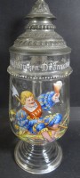Los 10052 <br>hoher Gründerzeit-Bierkrug mit Emaillemalerei und Spruch  "Stoßt an und ruft daneben: Die Frauen sollen leben!," Zinndeckel,  gut erhalten, H-25 cm