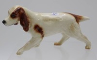 Auktion 340 / Los 9015 <br>Hunde-Figur, Cortendorf, polychr. Bemalung, ca. H-9cm L-16,5cm.