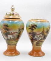 Auktion 345 / Los 9014 <br>Majolika-Vasen-Paar, älter, Landschaftsbemalung in Unterglasur, 1x Deckel fehlt, ca. H-50cm u. 36cm.