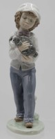 Auktion 351 / Los 8041 <br>Figur, Junge mit Hund, NAO Spain, Unterglasurfarben, H-20cm.