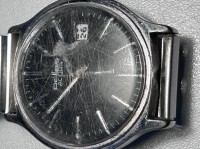 Auktion 348 / Los 2048 <br>mechan. HAU "Pallas" Adora,  mit Datum, Werk läuft, Metall-Zugband, Glas zerkratzt