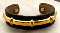 Auktion 371<br>Hermes Armspange, vergoldetes Messing auf Leder, gemarkt "Hermes-Paris"