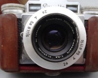 Auktion 357 / Los 16036 <br>Fototasche mit Kamere Braun Paxette und Blitzlicht Braun F26, Steinhell und Kreuznach-Objektiv in Tasche