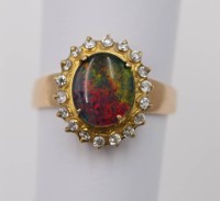 Auktion 361<br>Ring mit Feueropal dieser umringt von klaren Steinen, 18 K GG, ca. 8gr., RG 71