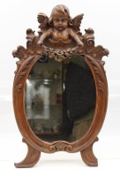 Auktion 364 / Los 14022 <br>Wandspiegel um 1900, Putto als Bekrönung, div. kl. Beschädigungen, ca. 35,5 x 33cm