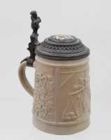 Auktion 368<br>alter Bierkrug, wohl Mettlach, reliefiert, Zinndeckel mit Porzellanmedaillon, ca. H-18cm