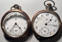 Auktion 369<br>2x HTU "Tramelan Watch&amp;Co" wohl Silbergeh&auml;use, 1x Glasring offen, 1x Werk steht, 1x l&auml;uft, aber da Emaille-Ziffernblatt besch&auml;digt, D-5 cm