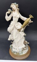 Auktion 370 / Los 15115 <br>Gro&szlig;e 35cm CAPODIMONTE &bdquo;FLORENCE&ldquo; M&auml;dchen-Figur mit Blumen im Haar, die eine Vase h&auml;lt   Signiert Giuseppe ARMANI, Handarbeit