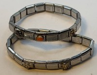 Auktion 371 / Los 1018 <br>2x Nomination Edelstahl Armb&auml;nder mit Gold Applikationen, mit div. Farbsteinen, 1x Feueropal, "UD Firenze" gemarkt,