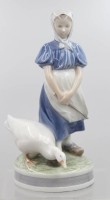 Auktion 373<br>G&auml;nsemagd, Royal Copenhagen, Entw. Christian Thomsen, u. sign., Modellnr. 527, polychrom bemalt in Unterglasurfarben, auf rundem Sockel, H- 23 cm, Brandfehler am Fuss