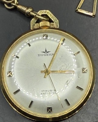 Auktion 373<br>mechan Dugena Taschenuhr, Plaque (vergoldet) an Uhrenkette 