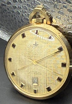 Auktion 373<br>mechan Dugena Taschenuhr, 17 Rubis,Datum,  vergoldet, Werk läuft, D-4 cm [1]