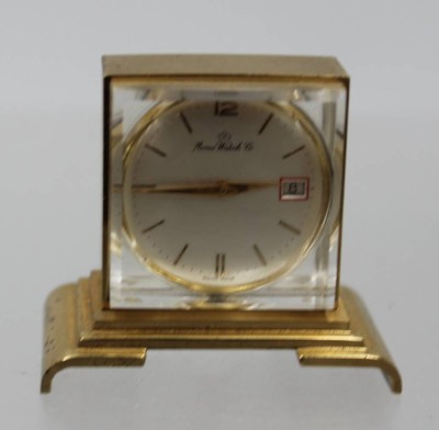 Auktion 373<br>kl. Tischuhr, Home Watch Co, Handaufzug, Werk läuft, H-4cm B-4,5cm [1]