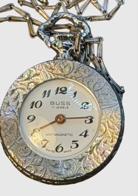 Auktion 375<br>mechan. Damenumhängeuhr an langer -Kette 