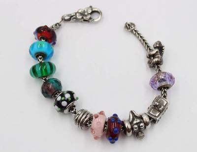 Auktion 376<br>Trollbeads-Armband, 925er Silber, 11 div. Charms, zus. ca. 45gr., L-ca. 18cm [1]