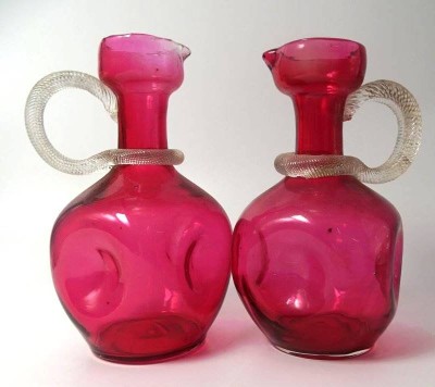 Auktion 347<br>Paar kl. Murano Krüge, wohl Weinkrüge, altrose mit klaren Griffen, seitlich gedrückt, H-15 cm [1]