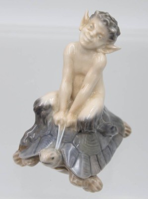 Auktion 359<br>Faun auf einer Schildkröte reitend, Royal Copenhagen, Modellnr. 858, Entw. Christian Thomsen , polychrom bemalt in Unterglasurfarben, H-10cm [1]