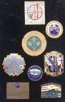 Auktion 362<br>7x div. Erinnerungsplaketten sowie 1x Stoffabzeichen, 1931/32, Zielfahrt nach Kiel 1932, Gau Kiel Nordmark 1932, Zielfahrt Kiel 1931, Motorradclub Bredstedt 1931 u. Fichtenhain Rennbahn Heide i. Holst 1932, Strahlenfahrt Flensburg 1931 und Badefahrt nach Grömitz 1931, auf Holz montiert, 41 x 28cm [1]