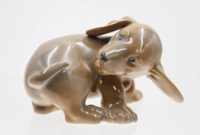 Auktion 367<br>Dackelwelpe, Royal Copenhagen, Entw. Olaf Mathiasen, Modellnr. 1407, polychr. Bemalung in Unterglasurfarben, H-7cm B-11cm [1]