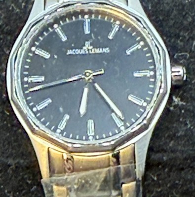 Auktion 370<br>Quartz DAU Jacques Lemans Armbanduhr 1-2013 Edelstahl, D-2,6 cm, neu in orig. Karton, Werk läuft, tw. mit orig. Folien, Karton beschädigt [1]