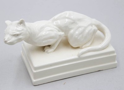 Auktion 371<br>Figur eines Pumas, Keramik, weiß glasiert, wohl 20er Jahre, leider an Nase bestossen, ca. H-11cm B-19,5cm [1]